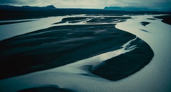 Movie still from “Voyage of Time” (2016), directed by Terrence Malick – A body of water that is very dark; Extreme Wide shot, High angle