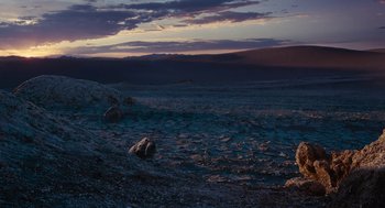 Movie still from “Voyage of Time” (2016), directed by Terrence Malick – A view of a desert at dusk with a sky background; Extreme Wide shot, High angle