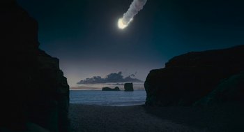 Movie still from “Voyage of Time” (2016), directed by Terrence Malick – The moon is setting in the sky over the ocean; Extreme Wide shot, Low angle