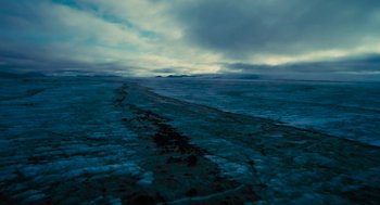 Movie still from “Voyage of Time” (2016), directed by Terrence Malick – A view of a body of water from a boat on a cloudy day; Extreme Wide shot, High angle
