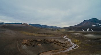 Movie still from “Voyage of Time” (2016), directed by Terrence Malick – A view of a valley with a river running through it; Extreme Wide shot, High angle