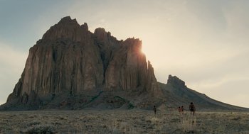 Movie still from “Voyage of Time” (2016), directed by Terrence Malick – A group of people standing on top of a hill; Extreme Wide shot, Low angle