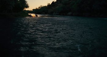 Movie still from “Voyage of Time” (2016), directed by Terrence Malick – A group of people in a boat on a body of water; Extreme Wide shot, High angle