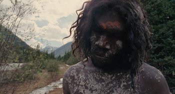 Movie still from “Voyage of Time” (2016), directed by Terrence Malick – A man with a face full of dirt; Close Up shot, High angle