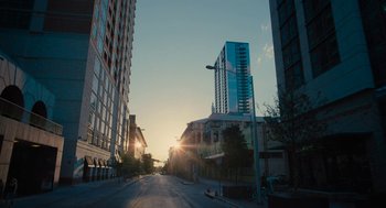 Movie still from “Voyage of Time” (2016), directed by Terrence Malick – The sun is setting over a city street; Extreme Wide shot, Low angle
