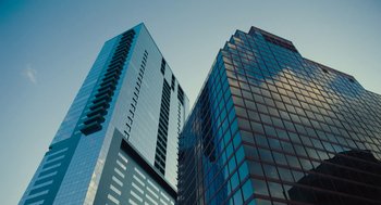 Movie still from “Voyage of Time” (2016), directed by Terrence Malick – View of some buildings in a city; Extreme Wide shot, Low angle