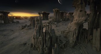 Movie still from “Voyage of Time” (2016), directed by Terrence Malick – A view of a desert landscape at night with the moon in the background; Extreme Wide shot, High angle