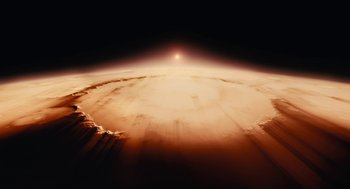 Movie still from “Voyage of Time” (2016), directed by Terrence Malick – A view of the earth from space at sunset; Extreme Wide shot, Overhead angle