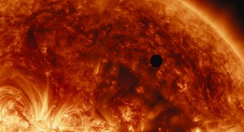 Movie still from “Voyage of Time” (2016), directed by Terrence Malick – A black hole in the center of the sun; Extreme Wide shot, Overhead angle