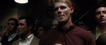 Movie still from “W.” (2008), directed by Oliver Stone – A person holding a drink in his hand; Close Up shot, Over the shoulder angle