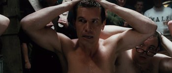 Movie still from “W.” (2008), directed by Oliver Stone – A man with his hands on his head in a crowd; Close Up shot, High angle
