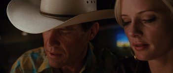 Movie still from “W.” (2008), directed by Oliver Stone – A person wearing a cowboy hat; Close Up shot, Over the shoulder angle