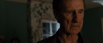 Movie still from “W.” (2008), directed by Oliver Stone – An old man with a beard is looking into the distance; Close Up shot, Low angle