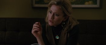 Movie still from “W.” (2008), directed by Oliver Stone – A woman sitting at a table holding her hand to her face; Close Up shot, Low angle