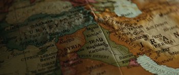 Movie still from “W.” (2008), directed by Oliver Stone – View of the middle east on a map; Extreme Close Up shot, High angle