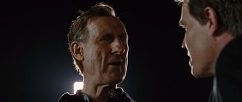 Movie still from “W.” (2008), directed by Oliver Stone – A person looking at the camera; Close Up shot, Low angle