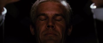 Movie still from “W.” (2008), directed by Oliver Stone – A man with his eyes closed; Extreme Close Up shot, Low angle