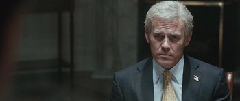 Movie still from “W.” (2008), directed by Oliver Stone – A man in a suit and a tie; Close Up shot, Over the shoulder angle