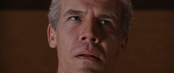 Movie still from “W.” (2008), directed by Oliver Stone – A man's face looking at the camera; Extreme Close Up shot, Low angle