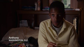 Movie still from “Waiting for Superman” (2010), directed by Davis Guggenheim – A man sitting on top of a bed in front of a window; Close Up shot, High angle