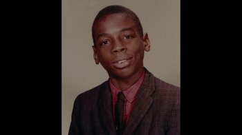 Movie still from “Waiting for Superman” (2010), directed by Davis Guggenheim – A young man wearing a suit and a tie; Extreme Close Up shot, High angle