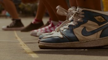 Movie still from “Waiting for Superman” (2010), directed by Davis Guggenheim – A pair of shoes on the ground; Extreme Close Up shot, Low angle