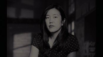 Movie still from “Waiting for Superman” (2010), directed by Davis Guggenheim – A black - and - white photo of a woman in a polka dot shirt; Close Up shot, Low angle