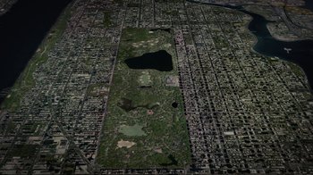 Movie still from “Waiting for Superman” (2010), directed by Davis Guggenheim – An aerial view of a large city with lots of trees; Extreme Wide shot, High angle