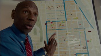 Movie still from “Waiting for Superman” (2010), directed by Davis Guggenheim – A person standing in front of a map; Close Up shot, High angle