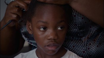 Movie still from “Waiting for Superman” (2010), directed by Davis Guggenheim – A person with their head up; Close Up shot, High angle