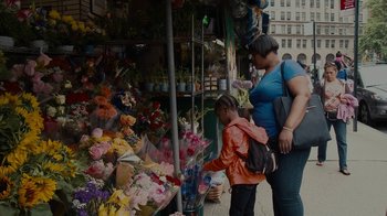 Movie still from “Waiting for Superman” (2010), directed by Davis Guggenheim – A woman and a child looking at flowers; Medium shot, Over the shoulder angle