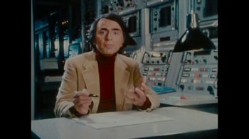 Movie still from “Waiting for Superman” (2010), directed by Davis Guggenheim – A man sitting at a table in front of a computer; Medium shot, Over the shoulder angle