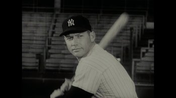 Movie still from “Waiting for Superman” (2010), directed by Davis Guggenheim – A black and white photo of a baseball player with a bat; Close Up shot, Low angle