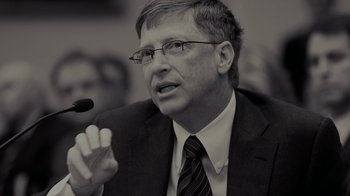 Movie still from “Waiting for Superman” (2010), directed by Davis Guggenheim – A black and white photo of a man in a suit and tie; Close Up shot, Over the shoulder angle