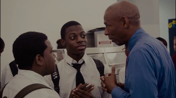 Movie still from “Waiting for Superman” (2010), directed by Davis Guggenheim – A group of young men standing next to each other; Medium shot, Over the shoulder angle