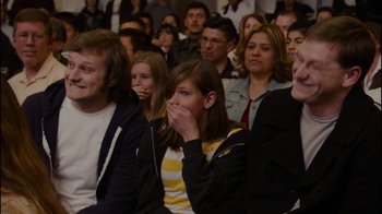 Movie still from “Waiting for Superman” (2010), directed by Davis Guggenheim – A group of people sitting in front of each other; Close Up shot, Over the shoulder angle
