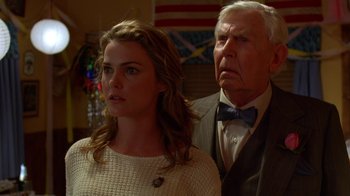 An older man and a younger woman standing next to each other