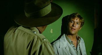 Movie still from “Wake in Fright” (1971), directed by Ted Kotcheff – A man in a hat looking into a mirror; Close Up shot, Over the shoulder angle