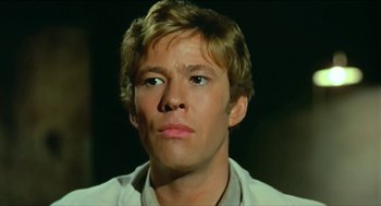 Movie still from “Wake in Fright” (1971), directed by Ted Kotcheff – A person wearing a white shirt; Close Up shot, Low angle