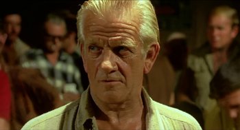 Movie still from “Wake in Fright” (1971), directed by Ted Kotcheff – An old man with a white beard and a white mustache; Close Up shot, Low angle