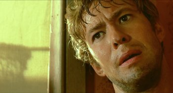 Movie still from “Wake in Fright” (1971), directed by Ted Kotcheff – A man's face with water on his face; Close Up shot, Low angle