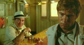 Movie still from “Wake in Fright” (1971), directed by Ted Kotcheff – Two men sitting at a table in front of drinks; Close Up shot, Low angle