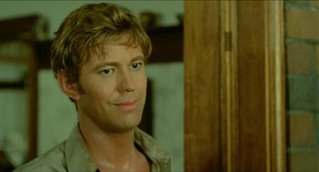 Movie still from “Wake in Fright” (1971), directed by Ted Kotcheff – A person wearing a brown shirt; Close Up shot, Over the shoulder angle