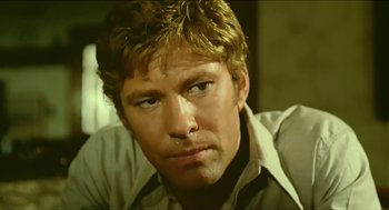 Movie still from “Wake in Fright” (1971), directed by Ted Kotcheff – A person wearing a shirt and tie; Close Up shot, Low angle