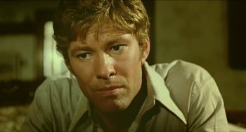 Movie still from “Wake in Fright” (1971), directed by Ted Kotcheff – A person wearing a dress shirt; Close Up shot, Low angle