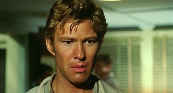 Movie still from “Wake in Fright” (1971), directed by Ted Kotcheff – A man's face in a dimly - lit room; Close Up shot, Low angle