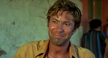 Movie still from “Wake in Fright” (1971), directed by Ted Kotcheff – A person wearing a yellow shirt; Close Up shot, Low angle