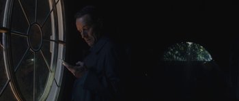 Movie still from “Wakefield” (2016), directed by Robin Swicord – A man is looking at his cell phone in the dark; Close Up shot, Low angle