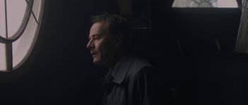 Movie still from “Wakefield” (2016), directed by Robin Swicord – A person wearing a jacket; Close Up shot, Over the shoulder angle