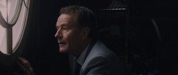 Movie still from “Wakefield” (2016), directed by Robin Swicord – A person wearing a suit and tie; Close Up shot, Over the shoulder angle